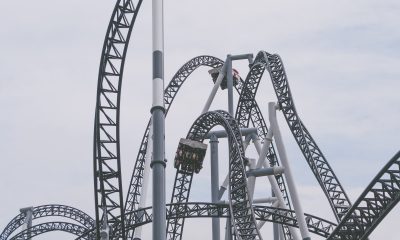 roller coaster under white clouds and blue sky
