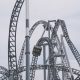 roller coaster under white clouds and blue sky