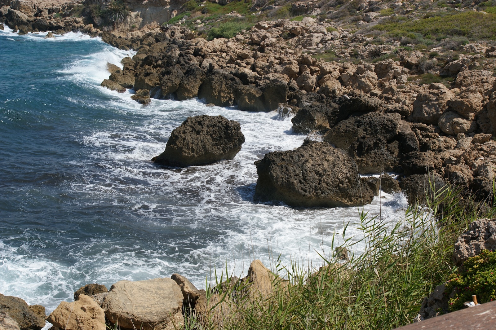 a rocky beach with a body of water