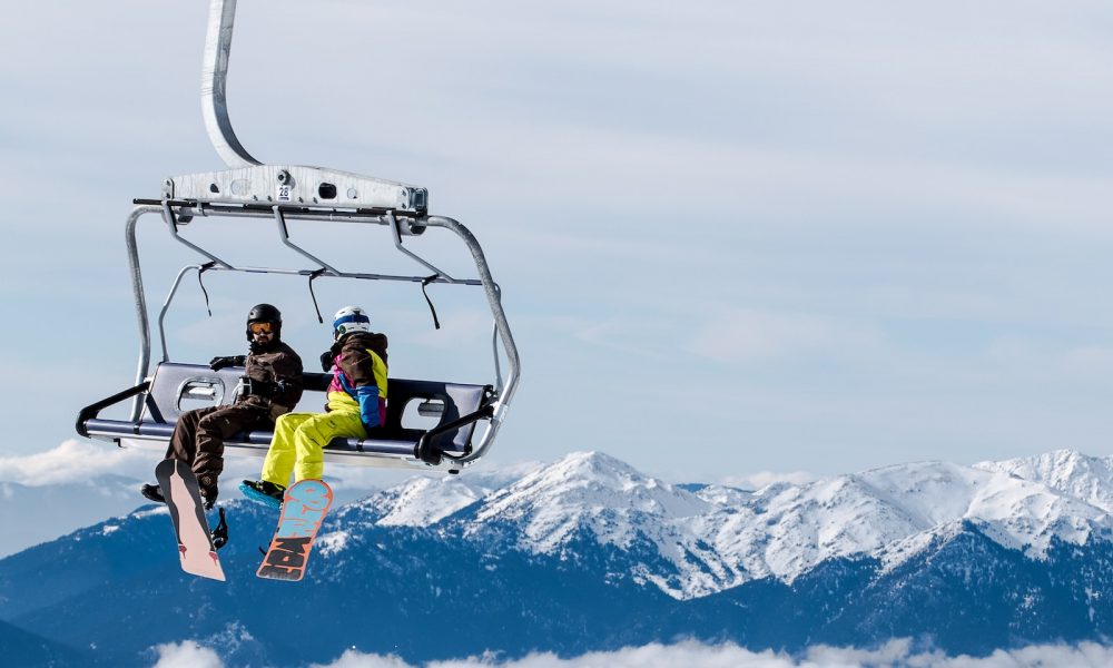 two person riding cable car